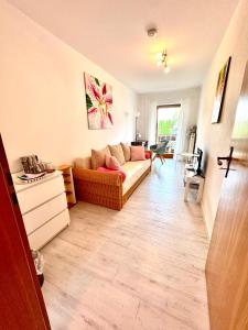 a living room with a couch and a table at Privatzimmer Hanna in Dießen am Ammersee