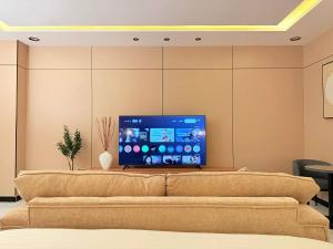 un salon avec un canapé et une télévision à écran plat dans l'établissement غرفة نوم واسعة استديو فندقية, à Riyad