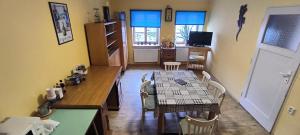 a kitchen and dining room with a table and chairs at Apartmán JAROSLAVA in Horšovský Týn