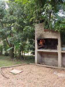 a brick oven with a fire in it at Surf homes in La Floresta +4 photos