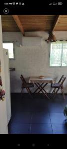 a table and two chairs in a room at Surf homes in La Floresta