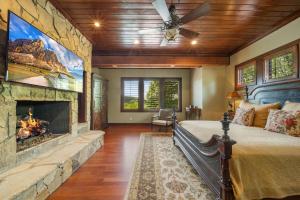 a bedroom with a fireplace and a bed in a room at Overlook at Wilderness Trail in Newland