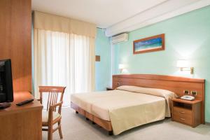Postel nebo postele na pokoji v ubytování Hotel Al Cigno
