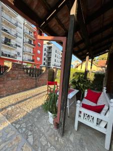 a porch with two chairs under a roof at Apartman Nemanja in Banja Koviljača +2 photos