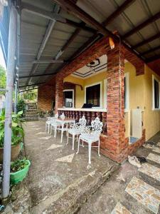a group of white tables and chairs on a patio at GUEST HOUSE at Tayabas Quezon! in Dapdap