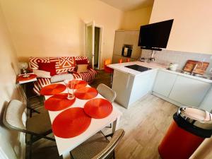 a kitchen and a living room with a table and chairs at CAMPBELL 100 DUNFERMLINE in Fife