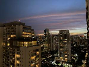 a city skyline at night with tall buildings at Cristal Studio Brooklin aero CGH Berrini in Sao Paulo