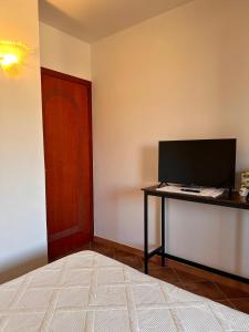 a bedroom with a desk with a computer on it at da Bonny in Villasimius +18 photos