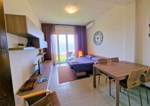 a living room with a table and a couch at Charme on the Lake - Dimora Spighetta in San Zeno di Montagna