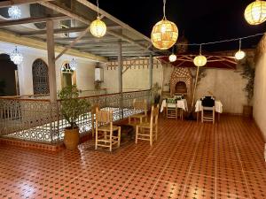 a dining room with tables and chairs and lights at Riad Tislite & SPA in Marrakesh