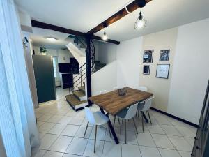 a dining room with a wooden table and chairs at Chambre Orb 1 etage in Béziers