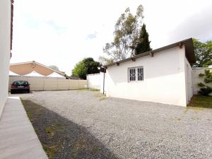 a white building with a car parked next to it at Nid du Merle, Pessac in Pessac