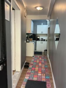 a hallway with a kitchen and a rug on the floor at Small House in İzmir +31 photos