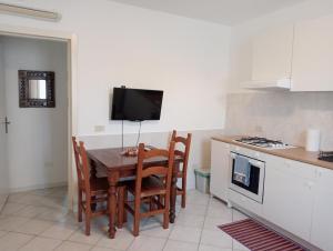 a kitchen with a table and chairs and a tv at Villa Voltina in Livorno