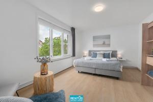 a bedroom with a bed and a window at Coppietershof - spacious home with garden near historic Bruges in Bruges