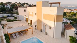 an aerial view of a house with a swimming pool at A'More Preko in Preko