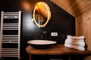 un bagno con lavandino e specchio di Mountain Escape Resort a Zărneşti Altre 33 foto