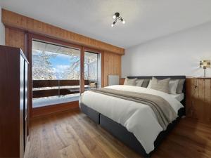 Postel nebo postele na pokoji v ubytování Ultimate Condo - 4 Valleys - Ski-in out - Swiss Alps