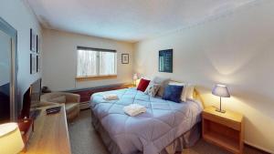 a bedroom with a bed and a living room at Woods Village 33 in Killington