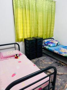 a room with two bunk beds and a window at imani homestay taman ira kangar perlis in Kangar +13 photos