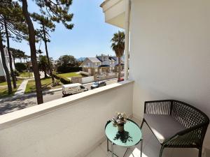 a balcony with a table and a chair and a window at Apartamento El Sureste 6824 in Noja