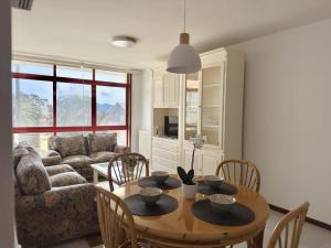 a living room with a table and a couch at Apartamento El Sureste 6824 in Noja
