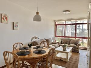 a living room with a table and a couch at Apartamento El Sureste 6824 in Noja