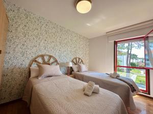 a bedroom with two beds and a window at Apartamento El Sureste 6824 in Noja +12 photos