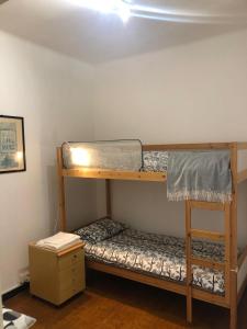 a bedroom with two bunk beds in a room at Casa JEANMARC in Moneglia