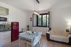a kitchen and living room with a table and a couch at Tra Monti E Mare in Cisano sul Neva