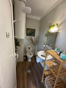 a bathroom with a toilet and a sink and a tub at Studio Seaven, Lozenets in Lozenets