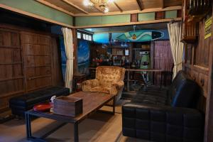 un soggiorno con un tavolo, un divano e un bar di 星が綺麗な町の古民家 Kominka いすみ市 a Shiigi