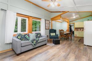 a living room with a couch and a table at Frog Hollow at Hocking Vacations in Logan