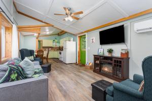 a living room with a couch and a tv and a fireplace at Frog Hollow at Hocking Vacations in Logan