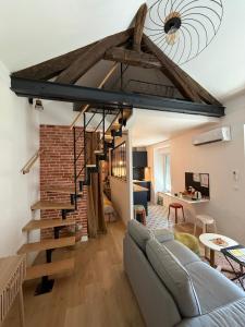 a living room with a couch and a brick wall at Maison Sorbier - Appartement 2 in Nevers