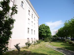 a white building with trees in front of it at Fisi Heritage Home&Apartaments in Shkodër