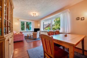 a dining room with a table and a living room at Ferienhaus Svea in Cuxhaven