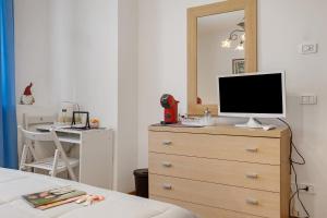 a bedroom with a dresser with a television on it at Camera Meridiana in Roncone +14 photos