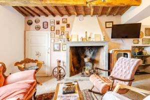 a living room with a fireplace and a tv at Antica Dimora Il Murrotto in Lanciole