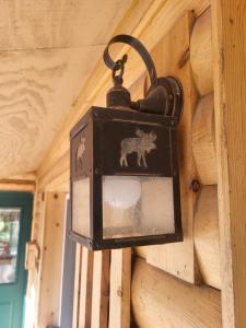 a lantern hanging on a wall with a horse on it at Moosewood Inn in Saint Ignace