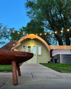 a small yellow house with a pointed roof at 2 Elm Water lakeside hideaway in Baston