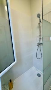 a bathroom with a shower with a glass door at Charmant Studio à 2 pas de la gare et du centre in Vernon