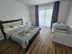 a bedroom with two beds and a window at Levander 2 in Králiky
