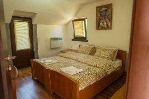 a small bedroom with a bed with two plates on it at Etno Gostilnica Villa Fulko in Ohrid