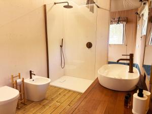 a bathroom with a tub and a sink and a shower at Riza Eco Tents in San Vito lo Capo