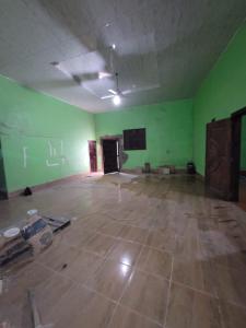 an empty room with green walls and a concrete floor at Residential House in Juigalpa