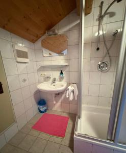 a small bathroom with a sink and a shower at Ferienhof Kohler in Fügen +36 photos
