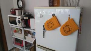 a refrigerator with two bags on the side of it at 幕山ハウス in Yugawara