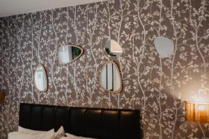 a bedroom with a bunch of mirrors on a wall at 4 Clovelly Court, Derby, DE22 1GS in Derby