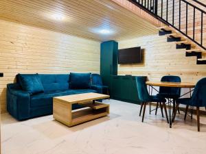a living room with a couch and a table at 13th Turn in Borjomi